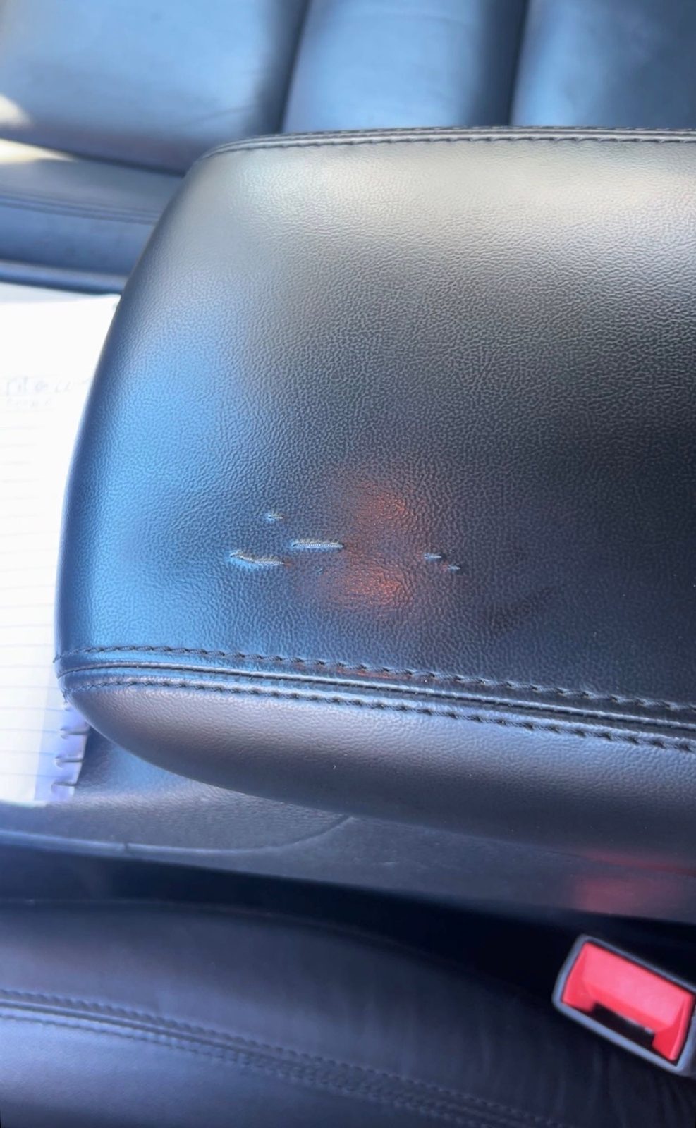 Torn and discolored center console before repair