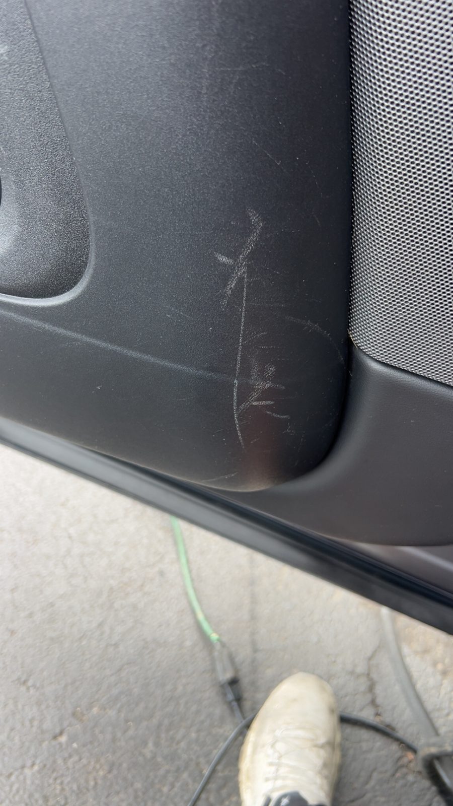 Scuffed door panel trim before repair