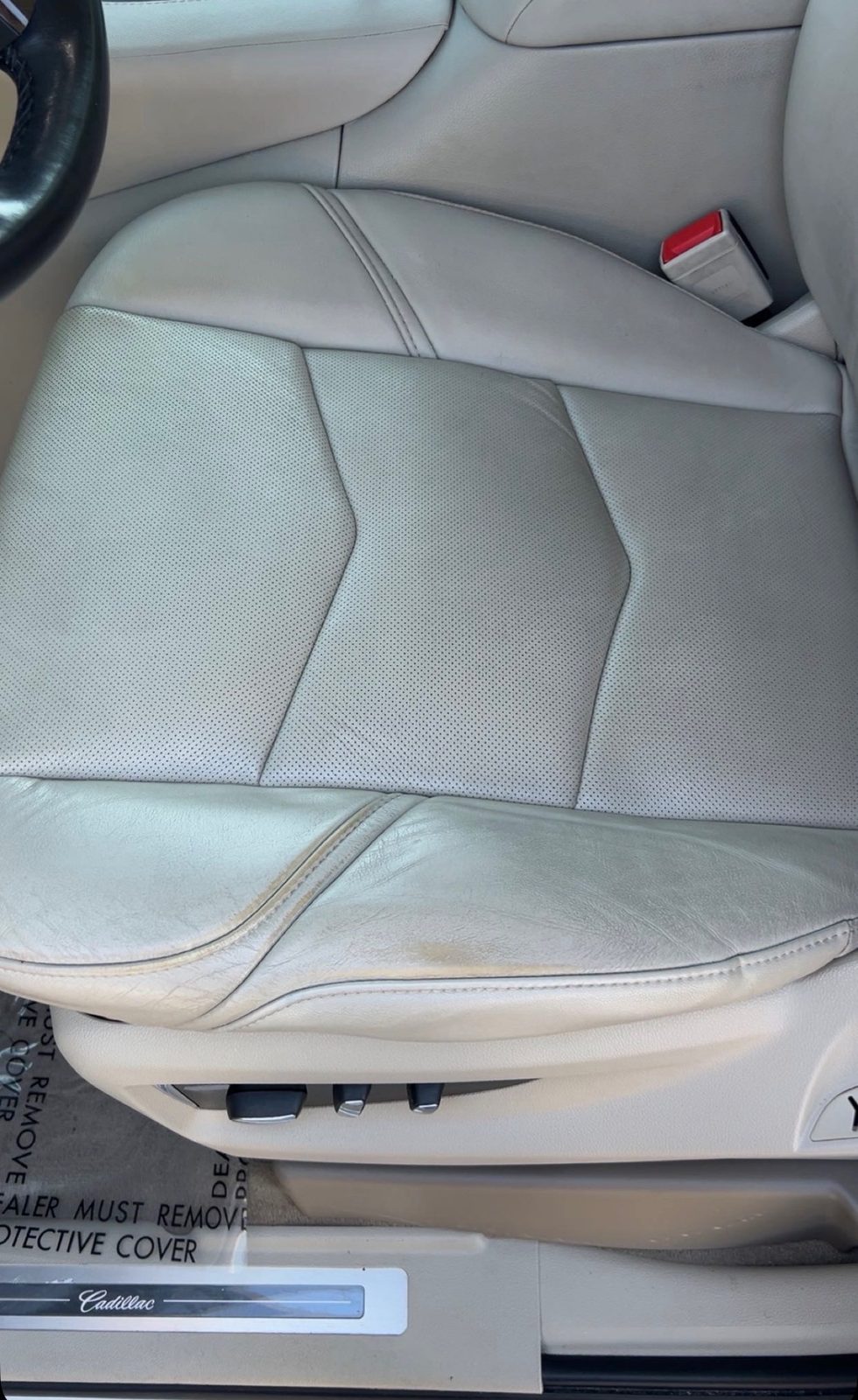 Discolored and worn seat leather before repair